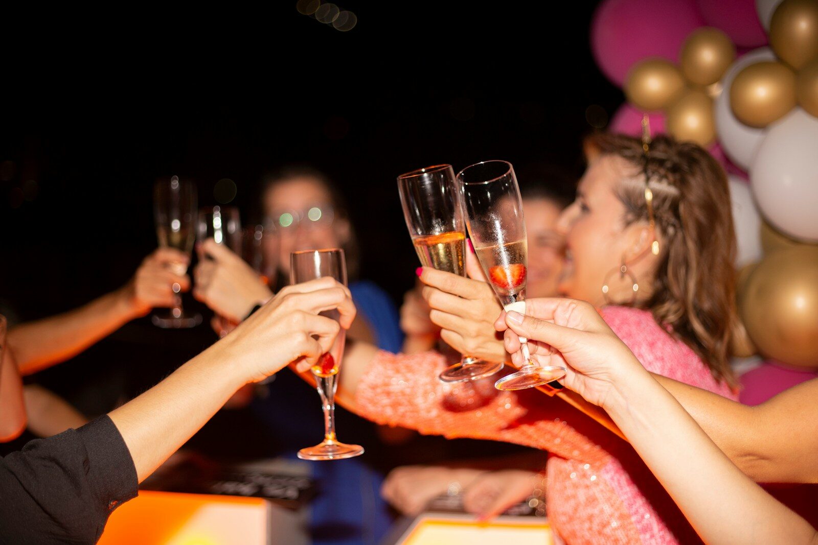 a group of people holding glasses of wine